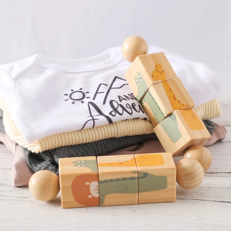 Wooden rotating block puzzles with folded baby clothes