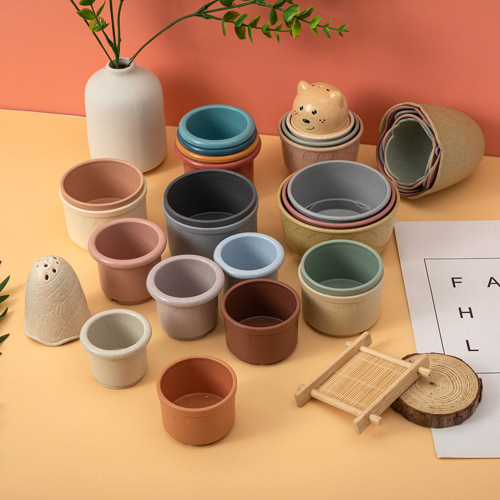 Silicone stacking cups in muted colours on a table