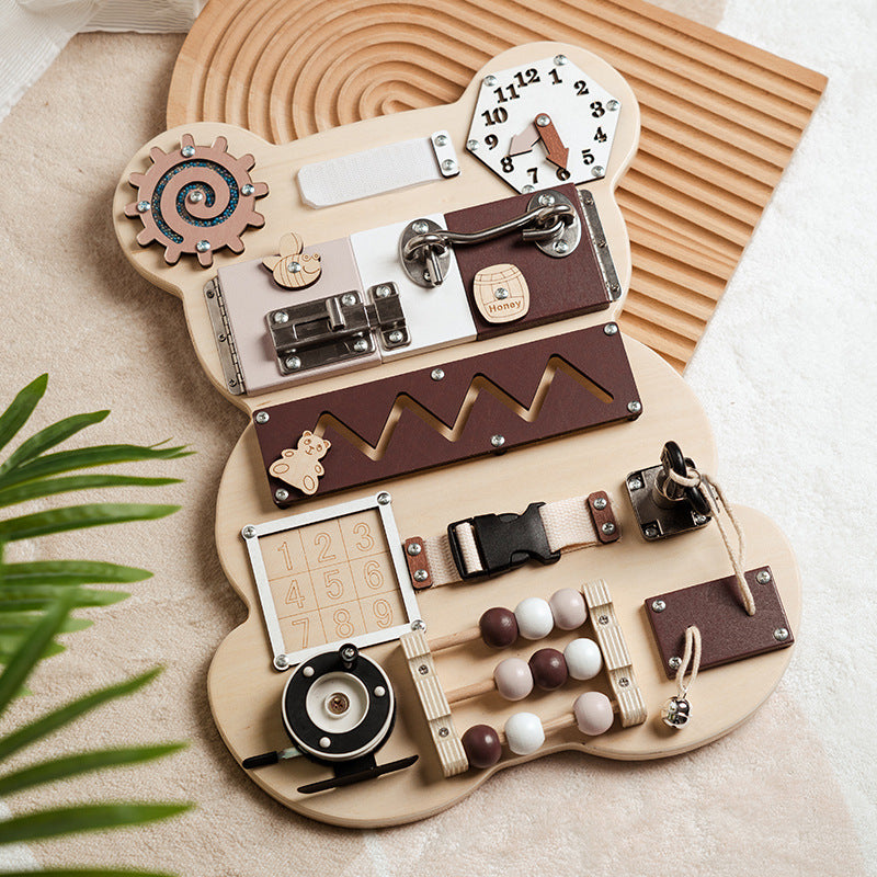 Bear wooden busy board on a cream rug