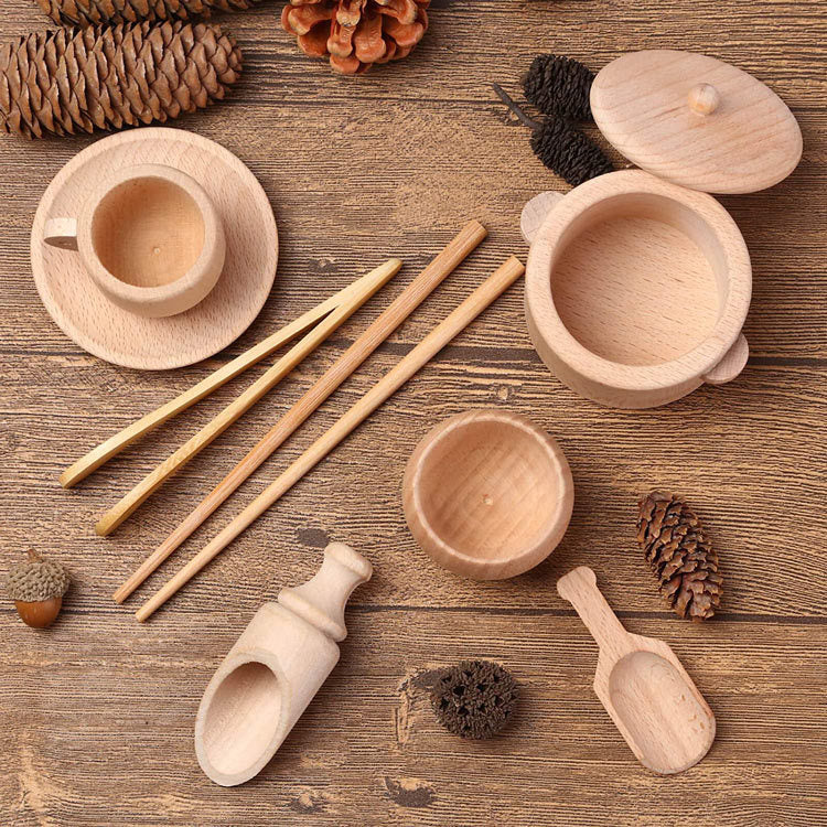 Wooden sensory bin tool set on wooden table with pine cones