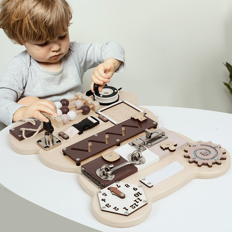 Child playing with the bear wooden busy board