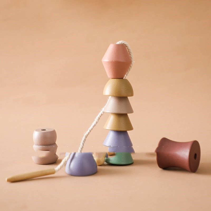 Wooden shapes lacing set stacked on the cord