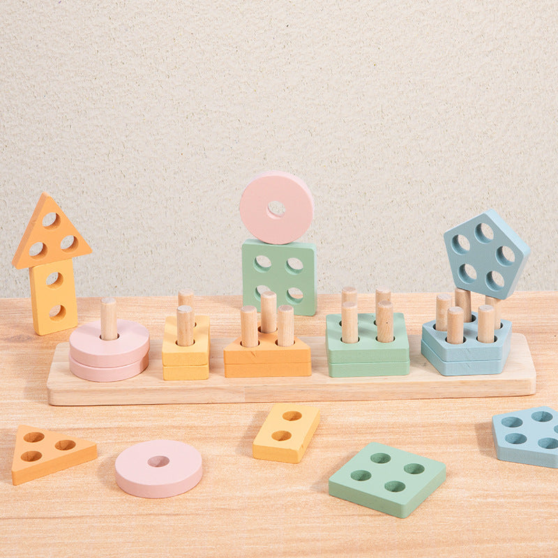 Pastel wooden shape stacker with pieces on a wooden table