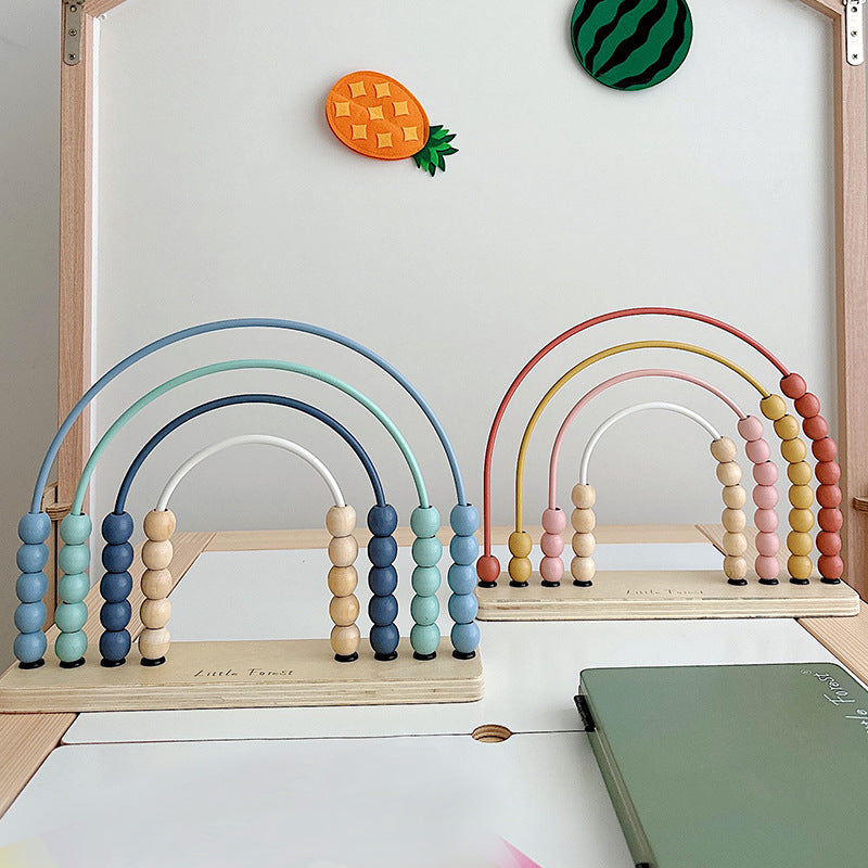 Blue and pink wooden rainbow abacus on a shelf