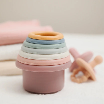 Discover the Montessori Silicone Stacking Cups at BubeBaby. Made from durable ABS, these versatile cups are perfect for beach, bath, and indoor play. Packaged in a net bag, they offer endless fun . Ideal for sensory play and skill development