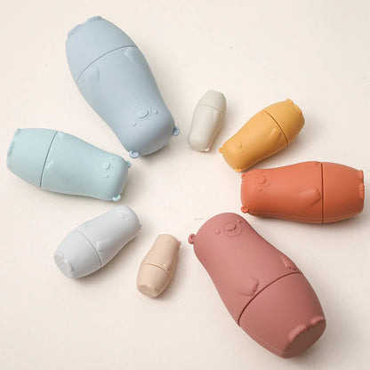 Montessori Silicone Bear Matryoshka Toy: A set of soft, stackable, bear-shaped nesting dolls in various sizes, made from pastel-colored, food-grade silicone. The bears fit inside one another, designed to encourage fine motor skills, sensory exploration, and cognitive development in young children