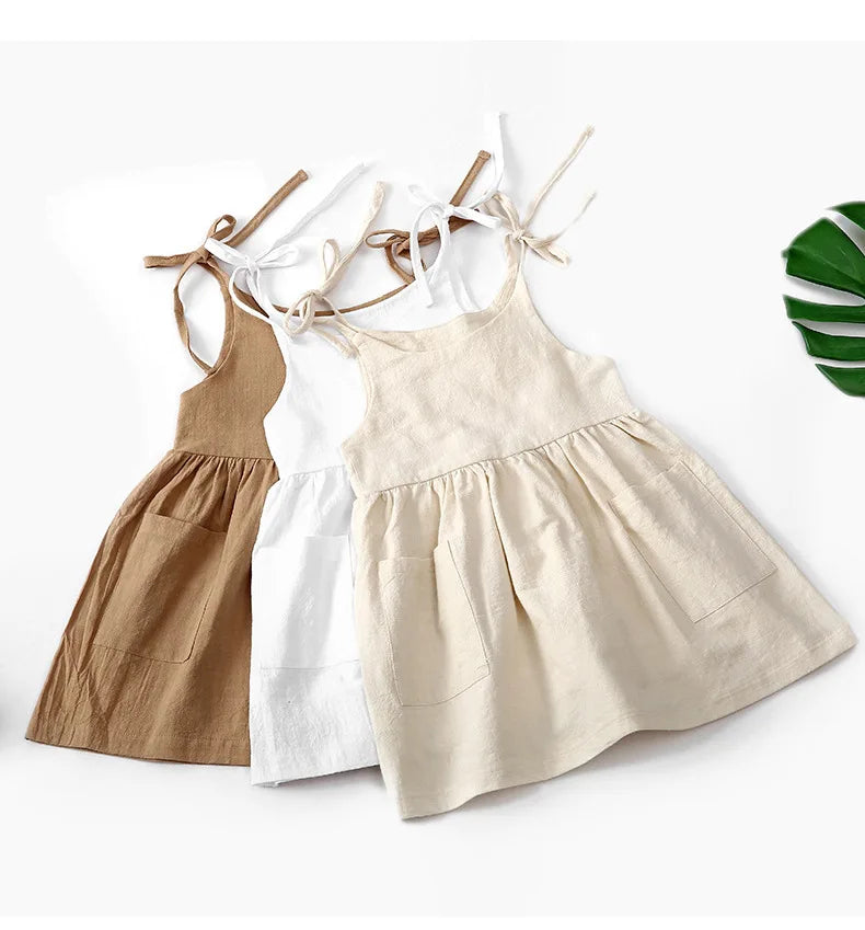 A BabyLove by Bubebaby light and breezy summer dress with spaghetti straps, designed for babies. The dress features a loose, relaxed fit and a soft, comfortable fabric, perfect for keeping little ones cool on warm days