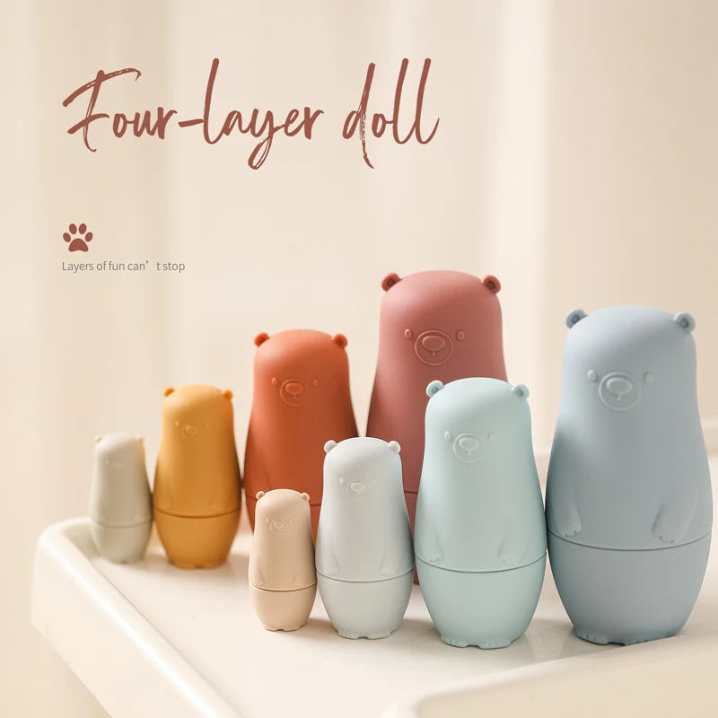 Montessori Silicone Bear Matryoshka Toy: A set of soft, stackable, bear-shaped nesting dolls in various sizes, made from pastel-colored, food-grade silicone. The bears fit inside one another, designed to encourage fine motor skills, sensory exploration, and cognitive development in young children