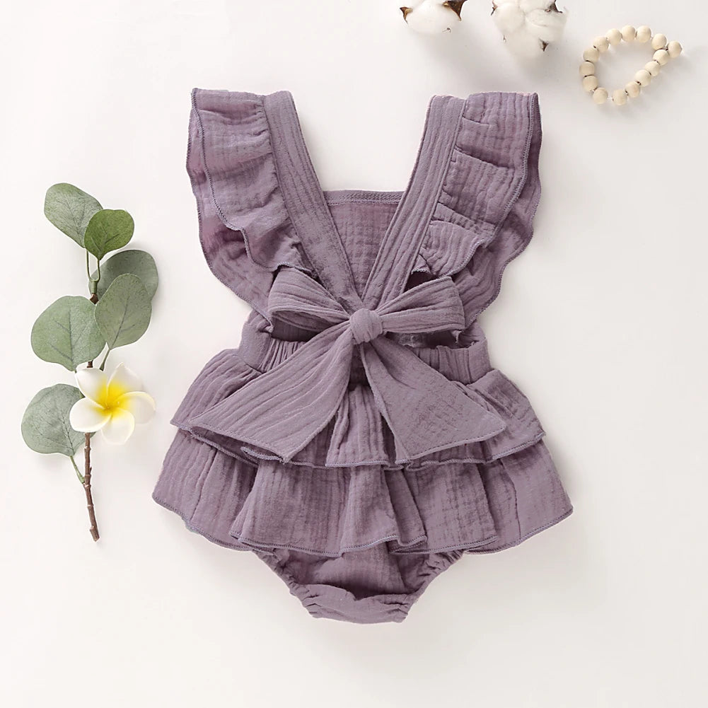 BabyLove Ruffled Jumpsuit at BubeBaby, perfect for baby girls aged 0-18 months. Made from soft cotton and polyester, this fashionable romper features a stylish O-neck and ruffled design.  it's ideal for spring and autumn