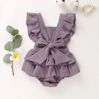 BabyLove Ruffled Jumpsuit at BubeBaby, perfect for baby girls aged 0-18 months. Made from soft cotton and polyester, this fashionable romper features a stylish O-neck and ruffled design.  it's ideal for spring and autumn