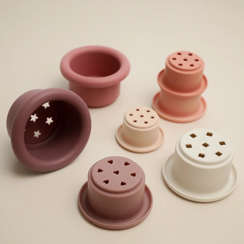 Discover the Montessori Silicone Stacking Cups at BubeBaby. Made from durable ABS, these versatile cups are perfect for beach, bath, and indoor play. Packaged in a net bag, they offer endless fun . Ideal for sensory play and skill development
