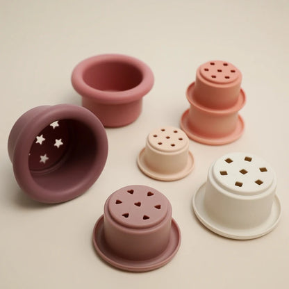 Discover the Montessori Silicone Stacking Cups at BubeBaby. Made from durable ABS, these versatile cups are perfect for beach, bath, and indoor play. Packaged in a net bag, they offer endless fun . Ideal for sensory play and skill development