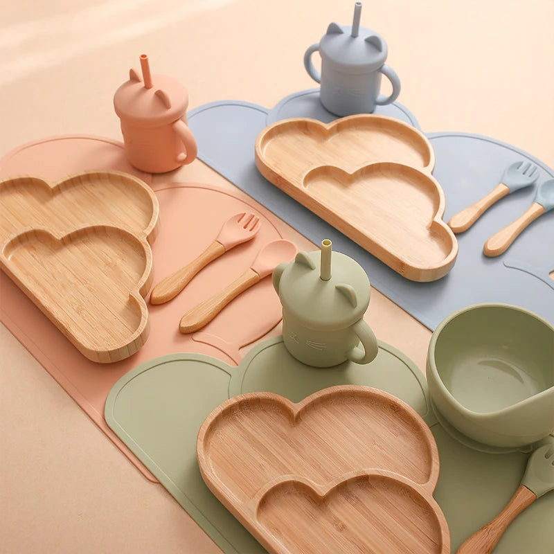 Eco-friendly Bubebaby Babylove 6-piece/7-piece Bamboo and Silicone Dinnerware Set for babies aged 6 months to 6 years. Made from BPA-free silicone and bamboo wood, this set includes a bowl, plate, fork, spoon, and teething toys, providing a safe and healthy mealtime experience. Certified by CE, EU, CIQ, and other standards for safety and quality