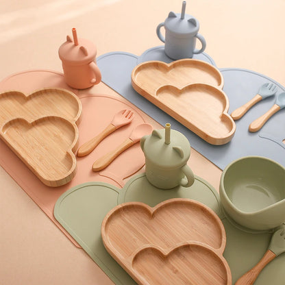 Eco-friendly Bubebaby Babylove 6-piece/7-piece Bamboo and Silicone Dinnerware Set for babies aged 6 months to 6 years. Made from BPA-free silicone and bamboo wood, this set includes a bowl, plate, fork, spoon, and teething toys, providing a safe and healthy mealtime experience. Certified by CE, EU, CIQ, and other standards for safety and quality