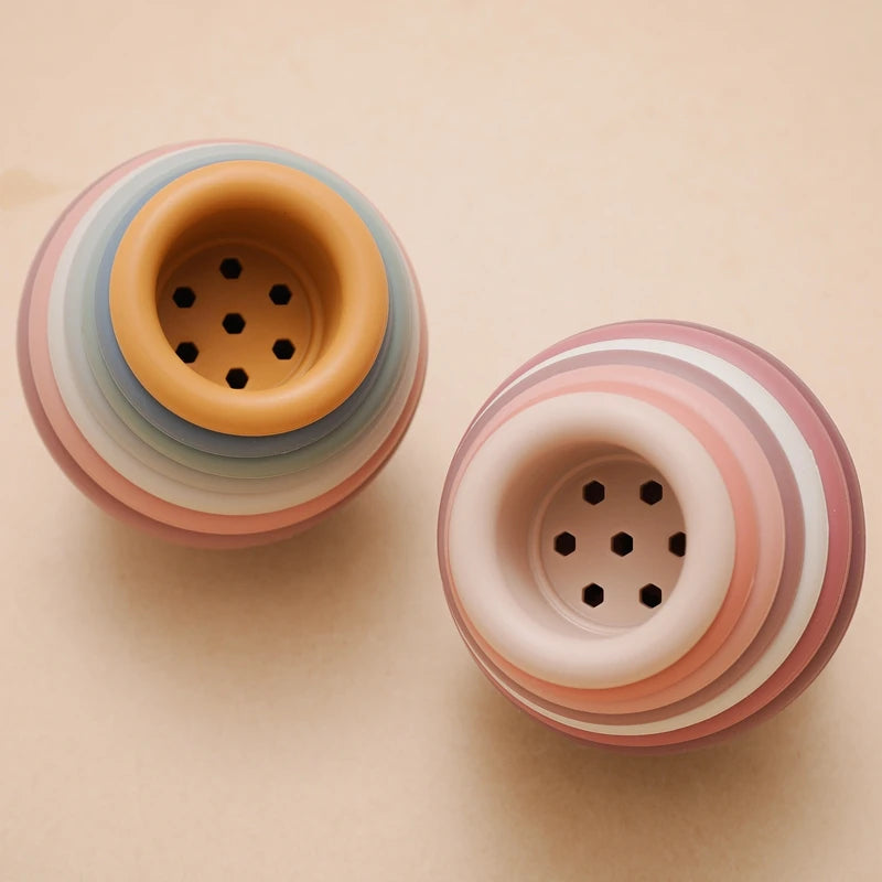 Discover the Montessori Silicone Stacking Cups at BubeBaby. Made from durable ABS, these versatile cups are perfect for beach, bath, and indoor play. Packaged in a net bag, they offer endless fun . Ideal for sensory play and skill development