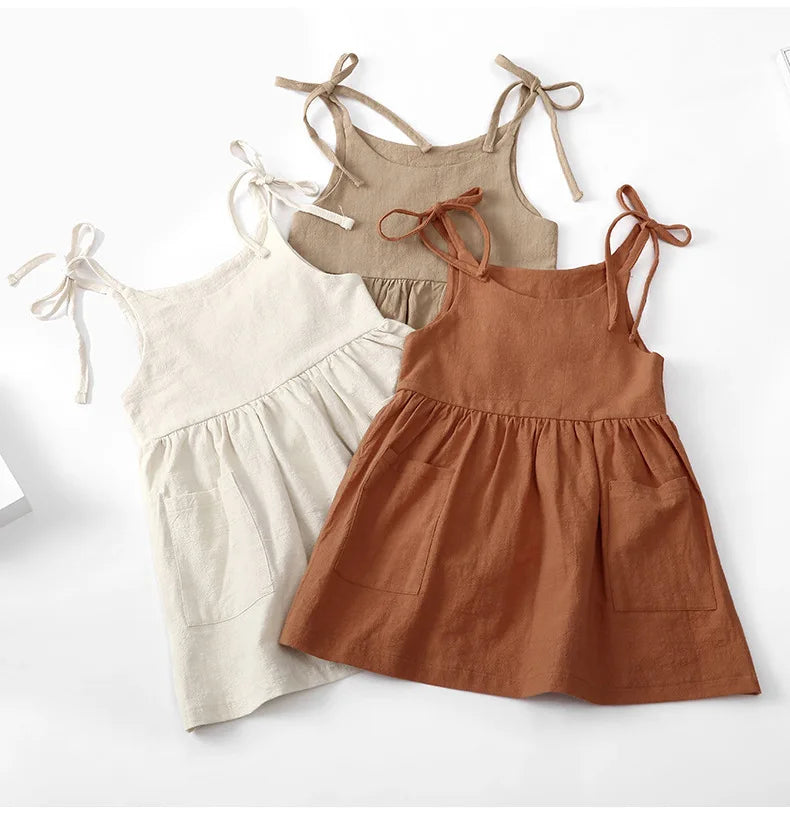 A BabyLove by Bubebaby light and breezy summer dress with spaghetti straps, designed for babies. The dress features a loose, relaxed fit and a soft, comfortable fabric, perfect for keeping little ones cool on warm days