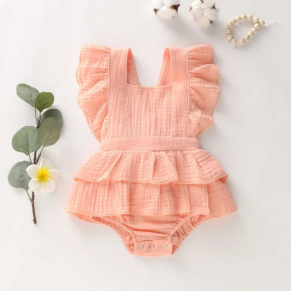 BabyLove Ruffled Jumpsuit at BubeBaby, perfect for baby girls aged 0-18 months. Made from soft cotton and polyester, this fashionable romper features a stylish O-neck and ruffled design.  it's ideal for spring and autumn