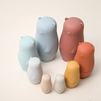 Montessori Silicone Bear Matryoshka Toy: A set of soft, stackable, bear-shaped nesting dolls in various sizes, made from pastel-colored, food-grade silicone. The bears fit inside one another, designed to encourage fine motor skills, sensory exploration, and cognitive development in young children