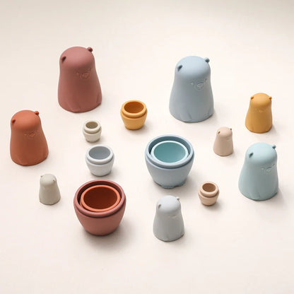 Montessori Silicone Bear Matryoshka Toy: A set of soft, stackable, bear-shaped nesting dolls in various sizes, made from pastel-colored, food-grade silicone. The bears fit inside one another, designed to encourage fine motor skills, sensory exploration, and cognitive development in young children