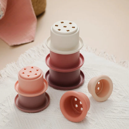 Discover the Montessori Silicone Stacking Cups at BubeBaby. Made from durable ABS, these versatile cups are perfect for beach, bath, and indoor play. Packaged in a net bag, they offer endless fun . Ideal for sensory play and skill development