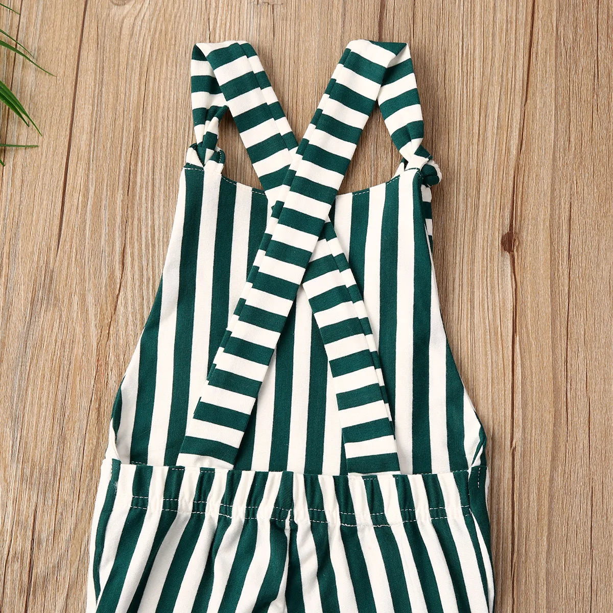 BabyLove Sleeveless Striped Romper at BubeBaby, perfect for baby girls from 0-5 years. Made from a comfy cotton-polyester blend, this versatile romper features a square collar, covered button closure, and short sleeves, ideal for all seasons. 