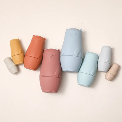 Montessori Silicone Bear Matryoshka Toy: A set of soft, stackable, bear-shaped nesting dolls in various sizes, made from pastel-colored, food-grade silicone. The bears fit inside one another, designed to encourage fine motor skills, sensory exploration, and cognitive development in young children