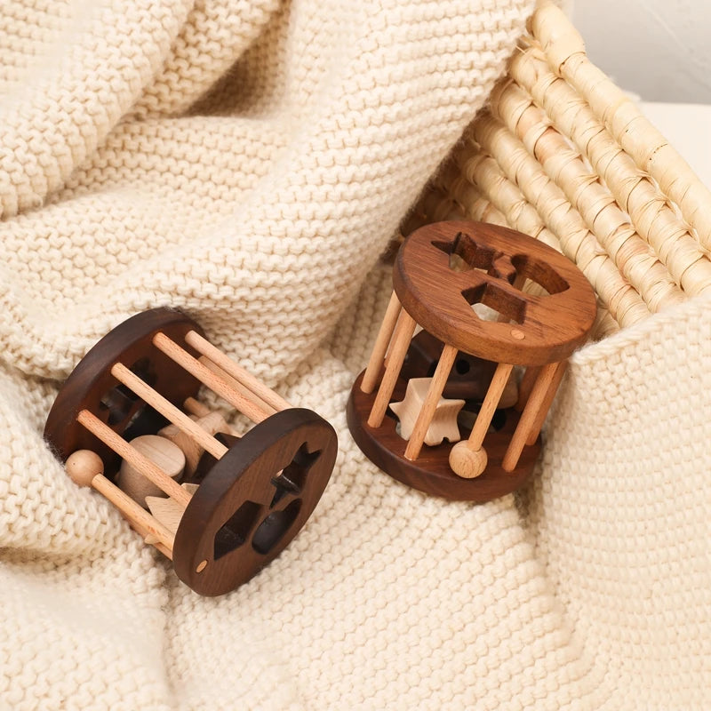 Two wooden shape sorter cages resting on a knitted blanket