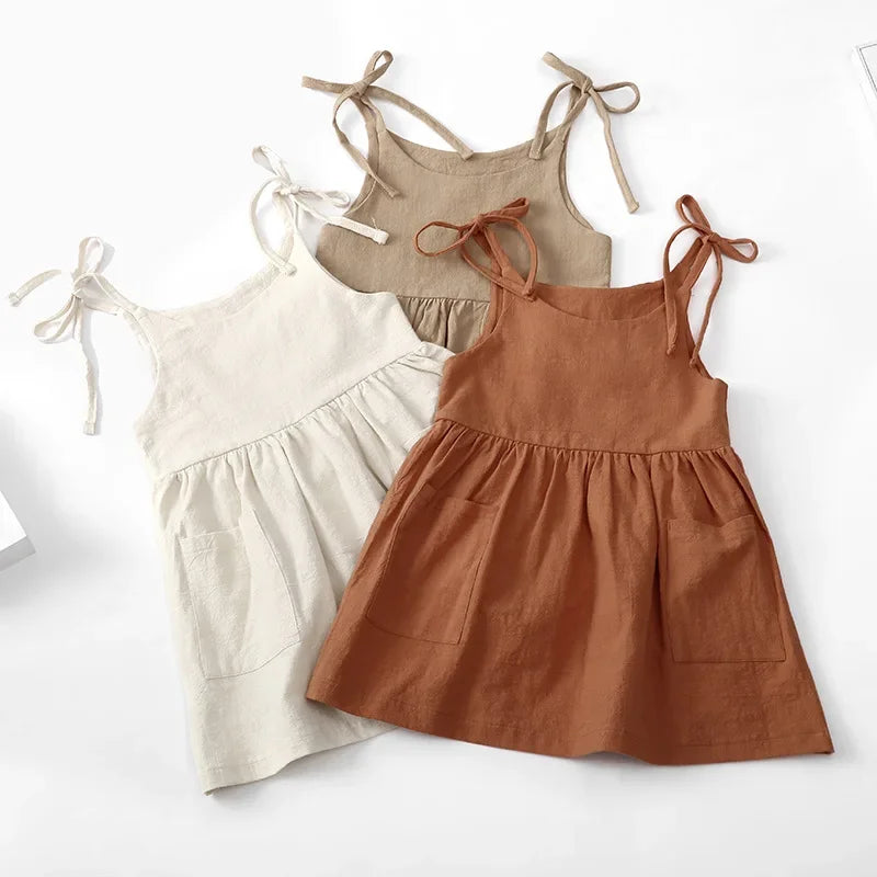 A BabyLove by Bubebaby light and breezy summer dress with spaghetti straps, designed for babies. The dress features a loose, relaxed fit and a soft, comfortable fabric, perfect for keeping little ones cool on warm days