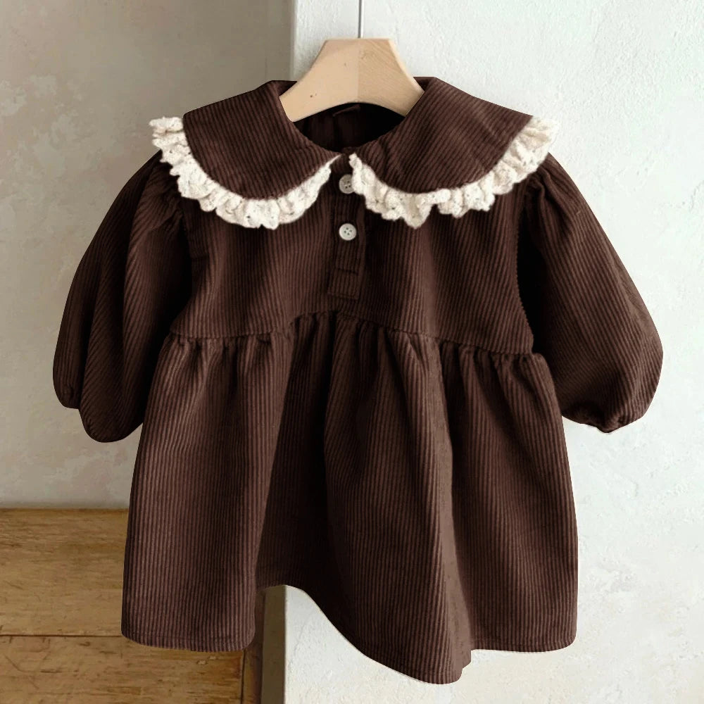 BabyLove Corduroy Peter Pan Collar Dress - A charming baby dress made from soft corduroy fabric, featuring a classic Peter Pan collar and delicate detailing, perfect for special occasions or everyday wear