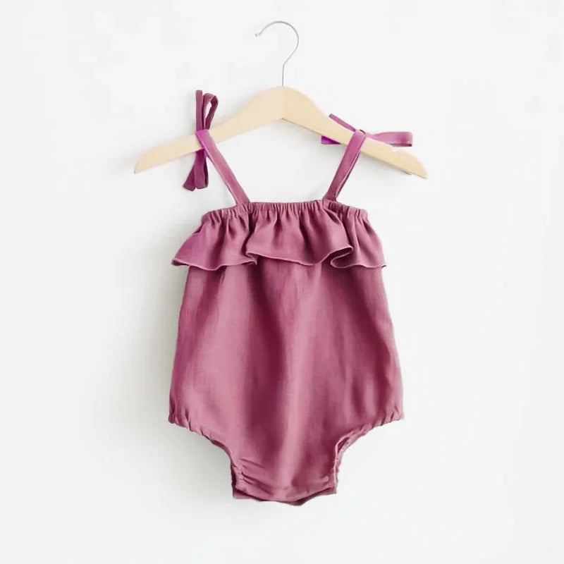 Shop the BabyLove Summer Romper at BubeBaby! A sleeveless, solid-colored romper with a ruffled bust . Made from 100% cotton, it's available for ages 0-24 months. Fits true to size and is perfect for summer. Choose the right size based on age and measurements for a comfortable fit