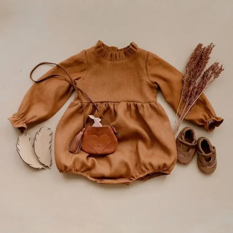 Bubebaby BabyLove Cotton Ruffled Long Sleeve buttoned Romper.  A cute and cozy baby romper made from soft cotton fabric, featuring long sleeves, a ruffled collar and wrists, with a snap closure for easy dressing. 