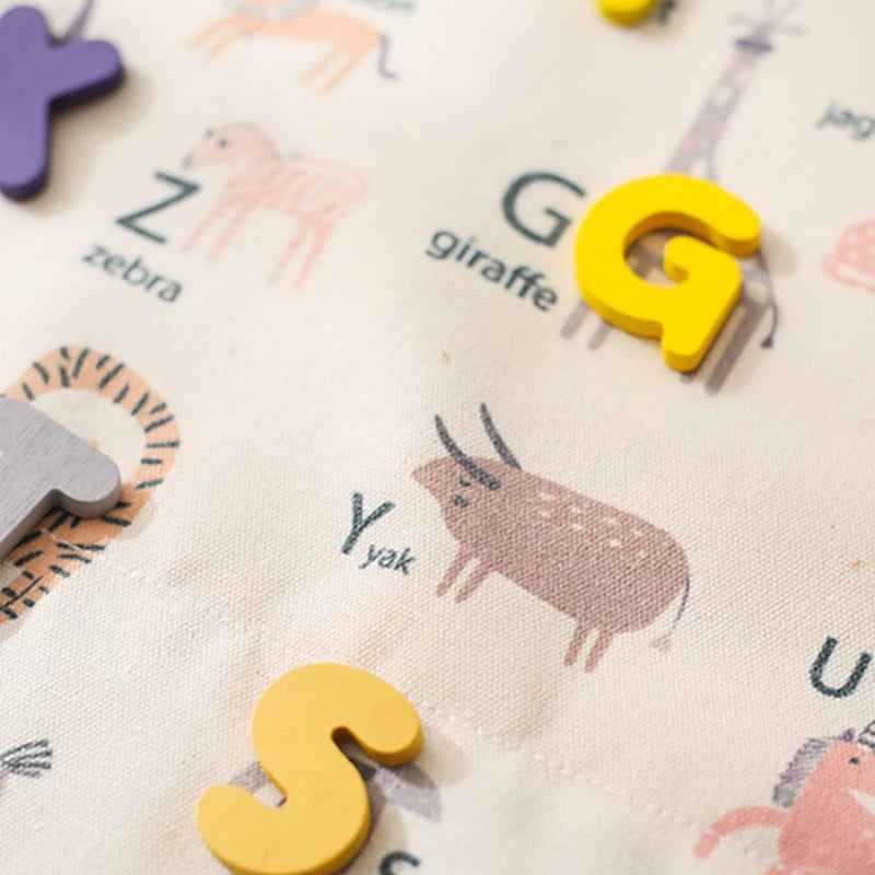 Close-up of the illustrated animal alphabet side with felt letters G and S