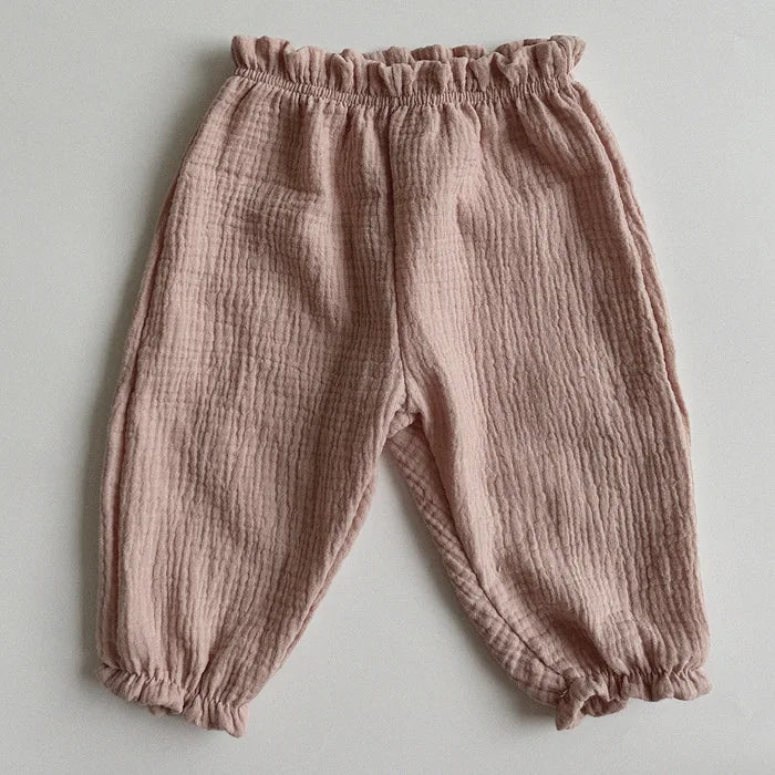 Soft muslin pants for babies from the BabyLove by Bubebaby collection. The pants are made of lightweight, breathable fabric with a gentle, stretchy waistband and a relaxed fit for comfort. The color is a soft, neutral tone, suitable for pairing with various baby tops