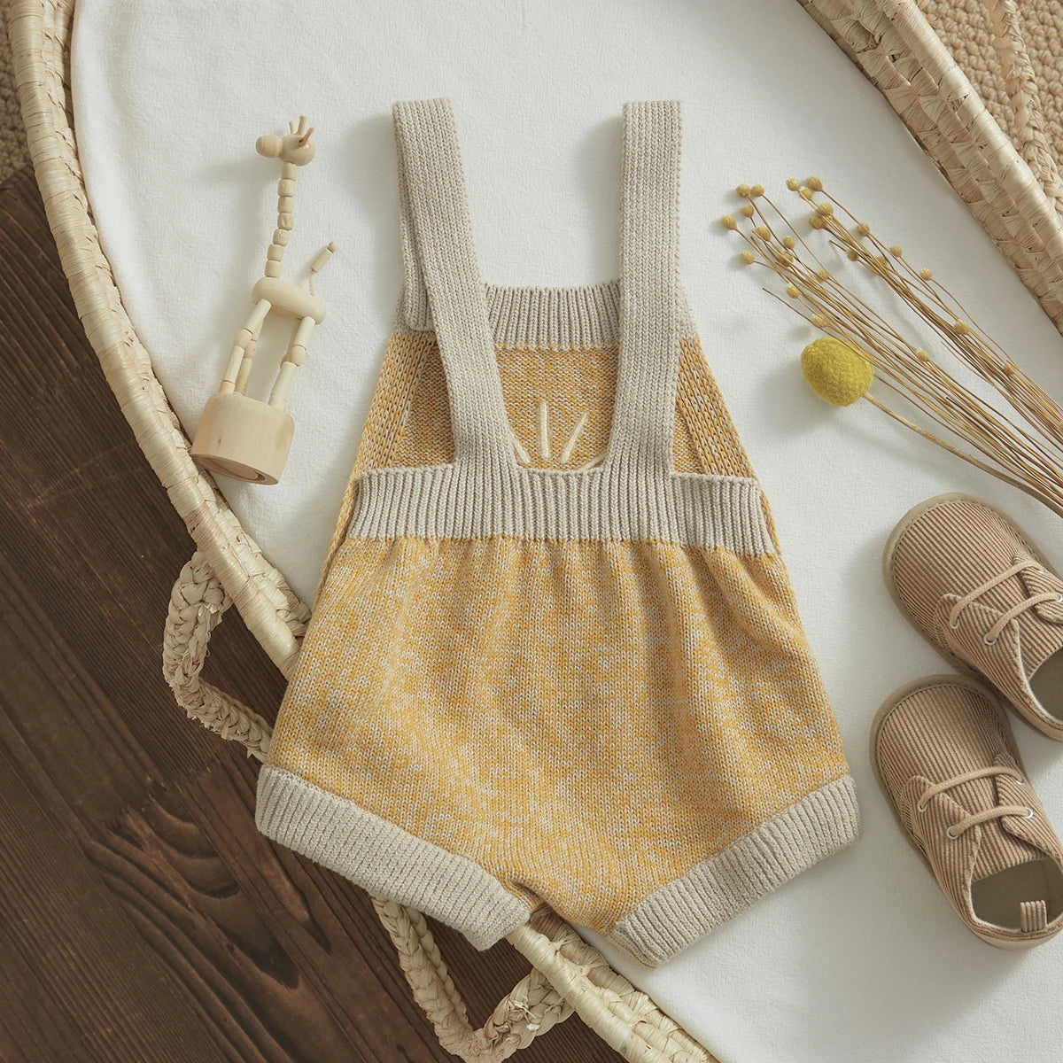 Baby unisex romper made from high-quality cotton and polyester, suitable for ages 0-24 months. The romper features a sleeveless design, straight collar, covered button closure, and a charming print pattern. Ideal for all seasons and available in various sizes to ensure a perfect fit.