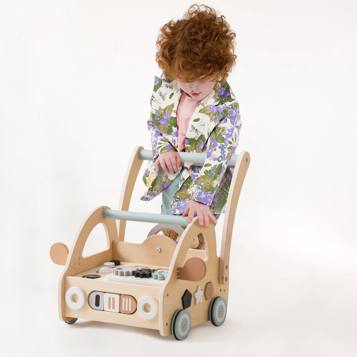 Toddler pushing the wooden activity walker