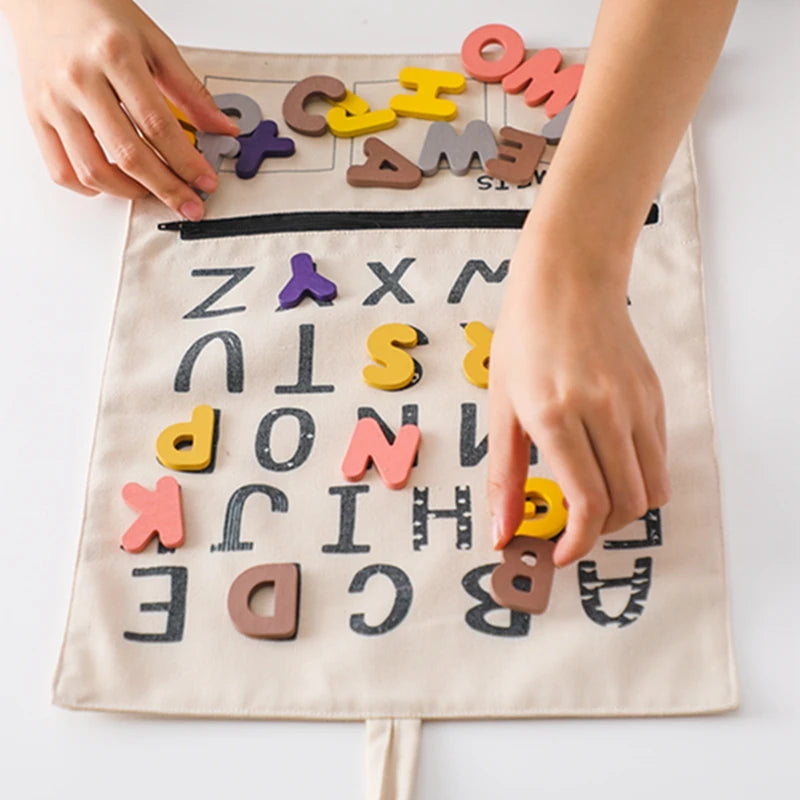 Child's hands placing felt letters on the ABC canvas board