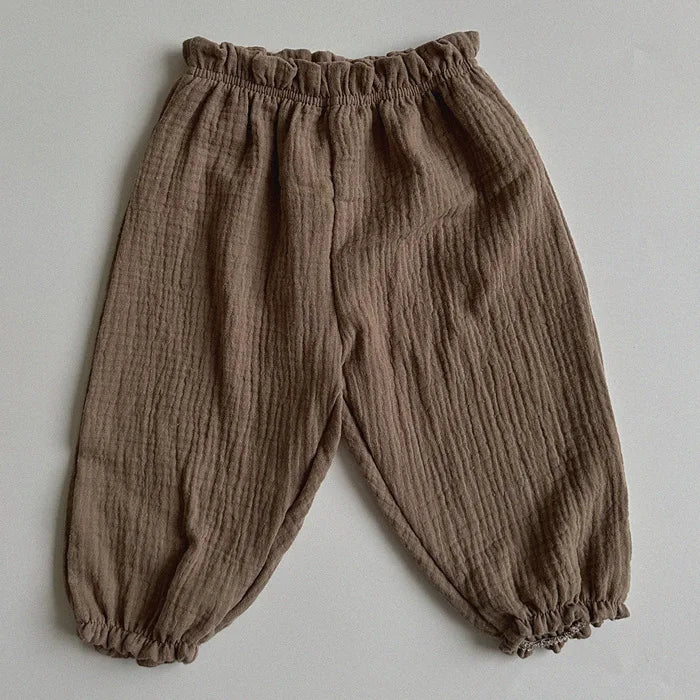 Soft muslin pants for babies from the BabyLove by Bubebaby collection. The pants are made of lightweight, breathable fabric with a gentle, stretchy waistband and a relaxed fit for comfort. The color is a soft, neutral tone, suitable for pairing with various baby tops