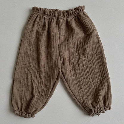 Soft muslin pants for babies from the BabyLove by Bubebaby collection. The pants are made of lightweight, breathable fabric with a gentle, stretchy waistband and a relaxed fit for comfort. The color is a soft, neutral tone, suitable for pairing with various baby tops