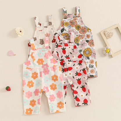 Bubebaby BabyLove Floral Jumpsuit Dungaree Romper. The romper features a floral pattern with a mix of vibrant colors. Featuring a pocket on the chest with shoulder straps, and snap closures at the bottom for easy diaper changes.