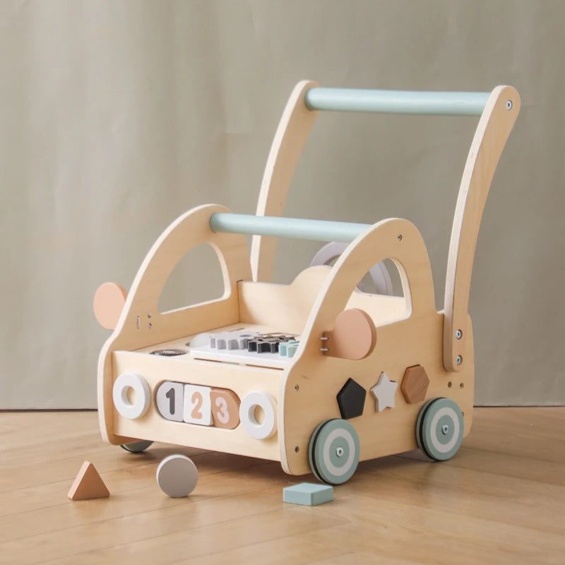 Wooden activity push walker with shape blocks on a wooden floor