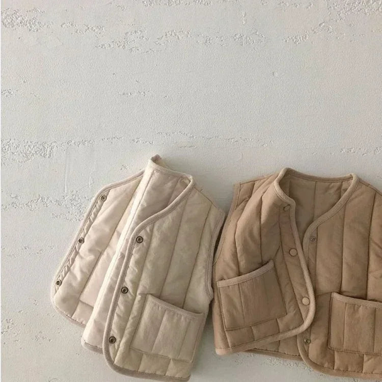 a cozy BabyLove by Bubebaby padded waistcoat, featuring soft, warm fabric and a cute design. Perfect for keeping your little one comfortable and stylish during cooler weather