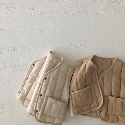 a cozy BabyLove by Bubebaby padded waistcoat, featuring soft, warm fabric and a cute design. Perfect for keeping your little one comfortable and stylish during cooler weather