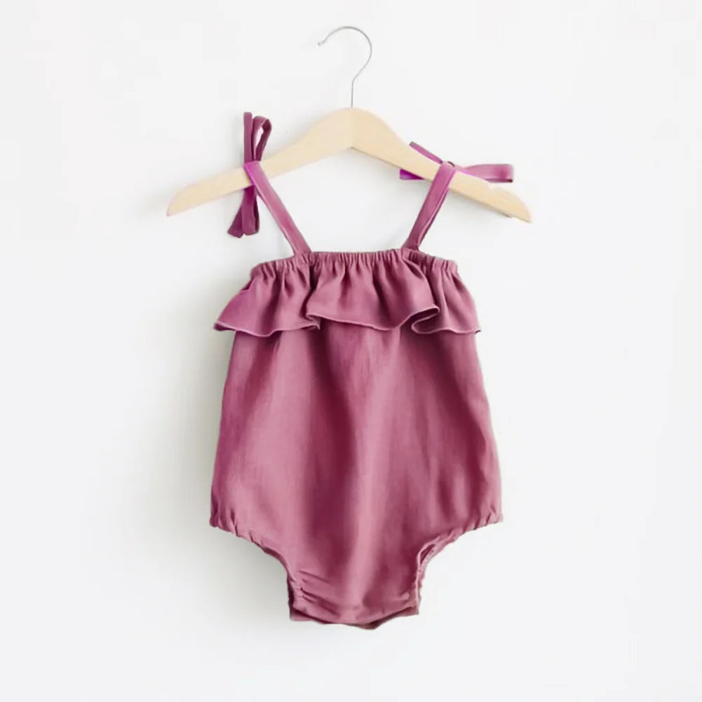 Shop the BabyLove Summer Romper at BubeBaby! A sleeveless, solid-colored romper with a ruffled bust . Made from 100% cotton, it's available for ages 0-24 months. Fits true to size and is perfect for summer. Choose the right size based on age and measurements for a comfortable fit