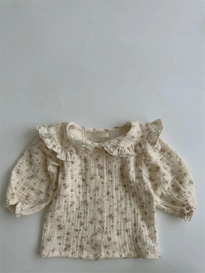 BabyLove by Bubebaby muslin/cotton full sleeve shirt in soft colors with a farm style feel. The shirt features a button-down front, peterpan collar , and gentle gathers at the sleeves for a comfortable fit. Ideal for keeping little ones cozy and stylish