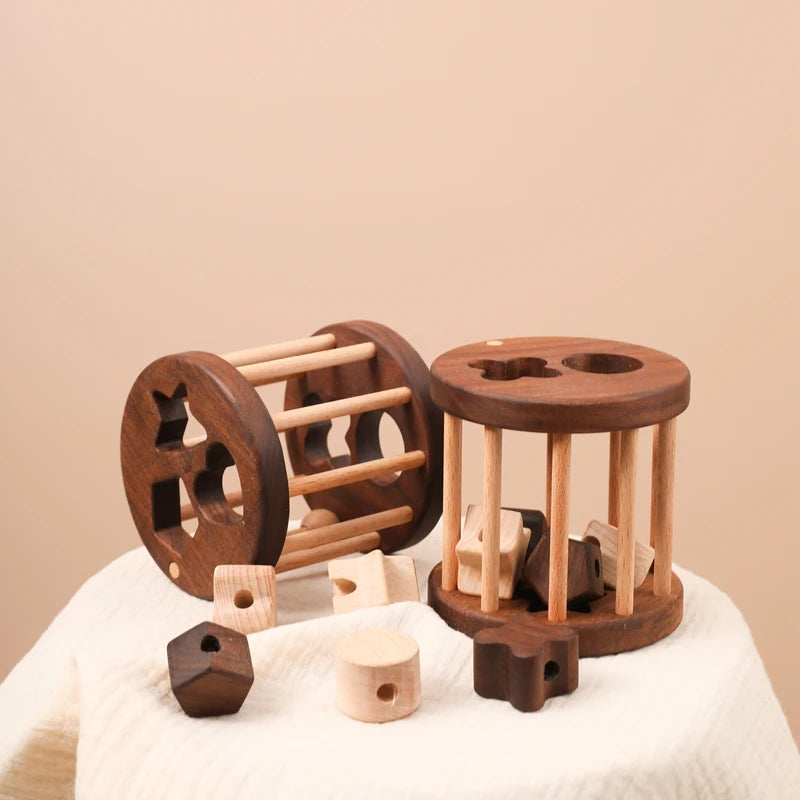 Walnut and beech wooden shape sorter cages with loose wooden shapes