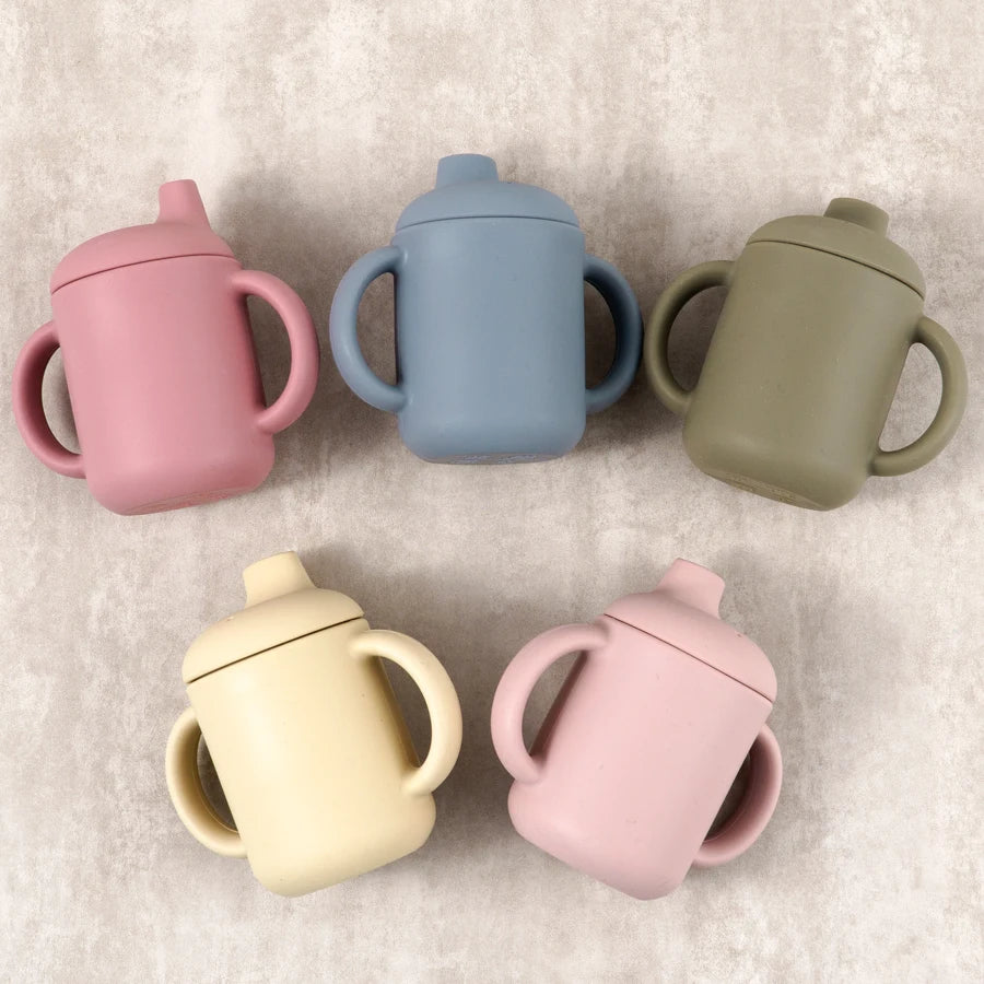 Silicone sippy cups in pink, blue, sage and cream with handles