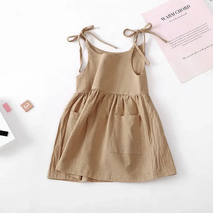 A BabyLove by Bubebaby light and breezy summer dress with spaghetti straps, designed for babies. The dress features a loose, relaxed fit and a soft, comfortable fabric, perfect for keeping little ones cool on warm days
