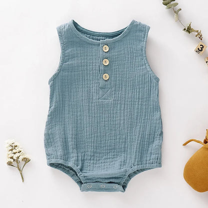 the BabyLove Sleeveless Romper at BubeBaby, designed for babies 0-24 months. Made from soft cotton, this solid-colored romper features an O-neck and covered button closure, perfect for summer