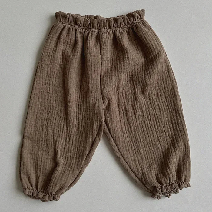 Soft muslin pants for babies from the BabyLove by Bubebaby collection. The pants are made of lightweight, breathable fabric with a gentle, stretchy waistband and a relaxed fit for comfort. The color is a soft, neutral tone, suitable for pairing with various baby tops