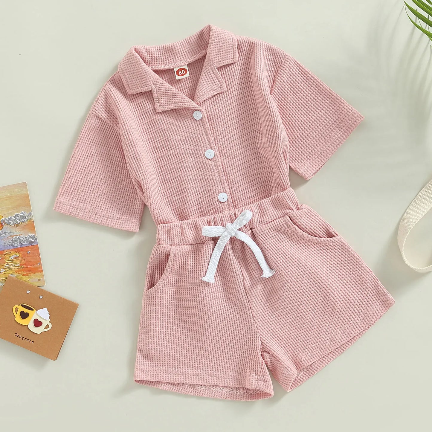 Shop our Bubebaby BabyLove summer baby unisex sets made from cotton and polyester, featuring a V-neck, single-breasted closure, and short sleeves. Available for ages 0-4 years with sizes ranging from 80-120 cm. The set includes a top and shorts with a cute print pattern, fitting true to size. Ideal for warm weather, these sets ensure comfort and style for your little ones.